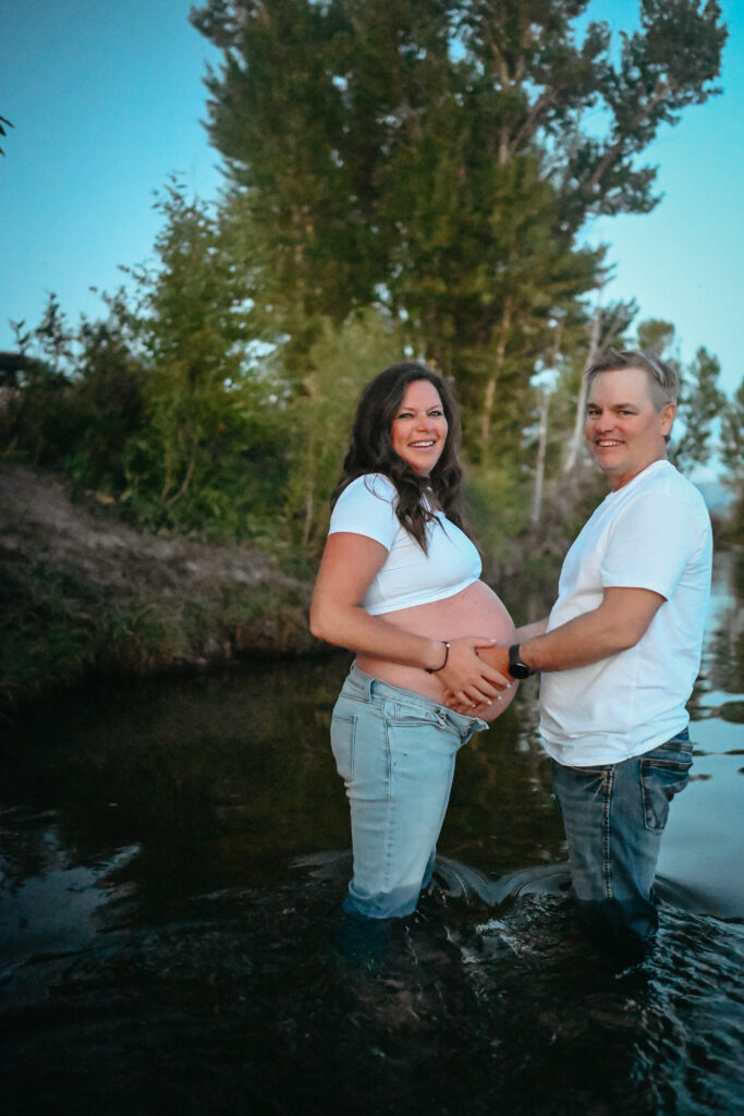 Pregnant mama with her husbands hands on her belly during her driggs Maternity Session