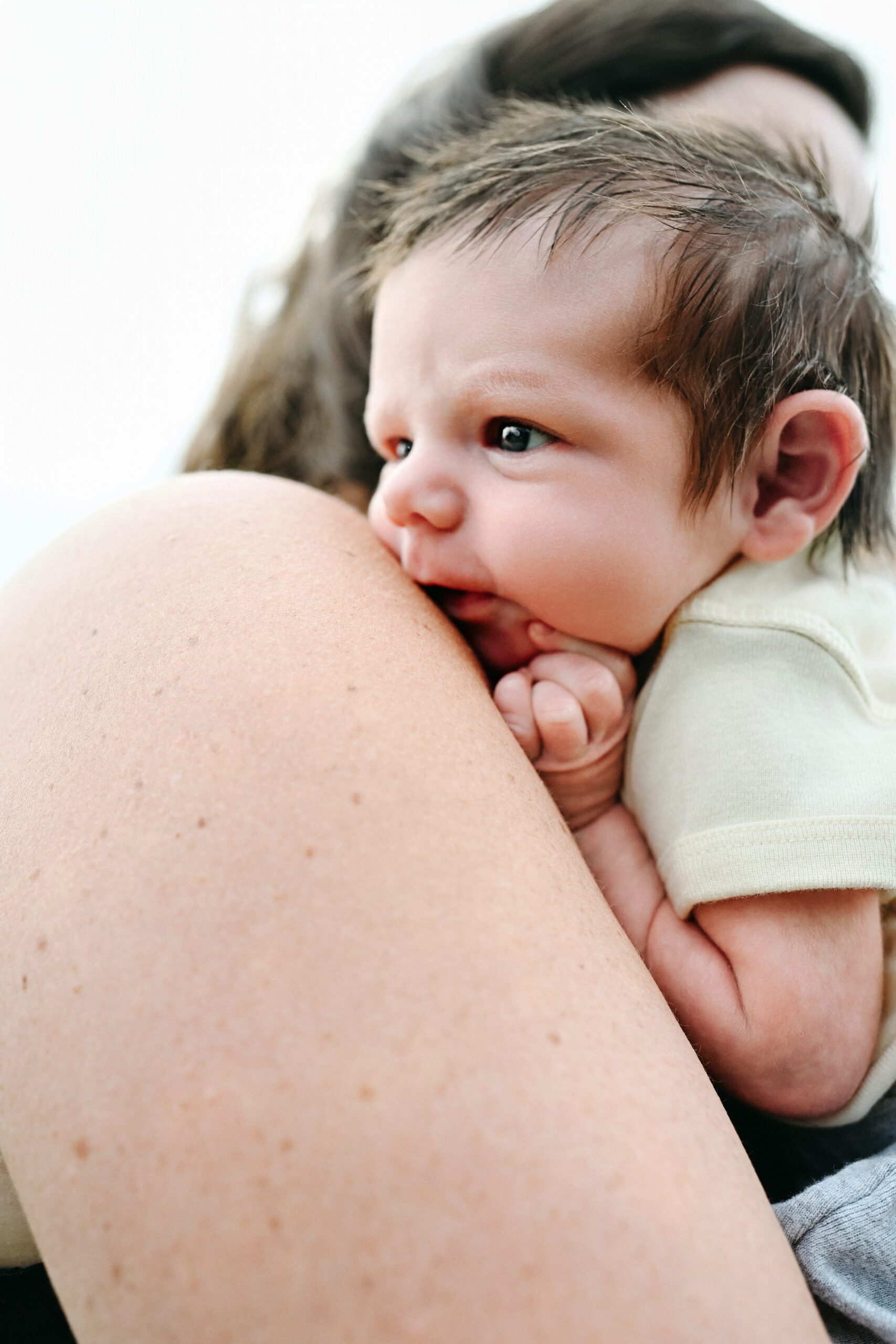 Newborn being held by mom outside at teton valley newborn photography session