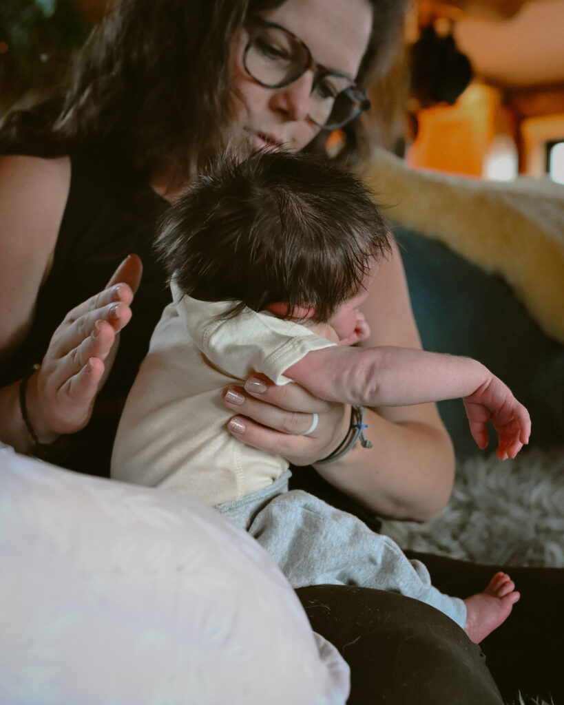Mother burping baby during newborn photography session