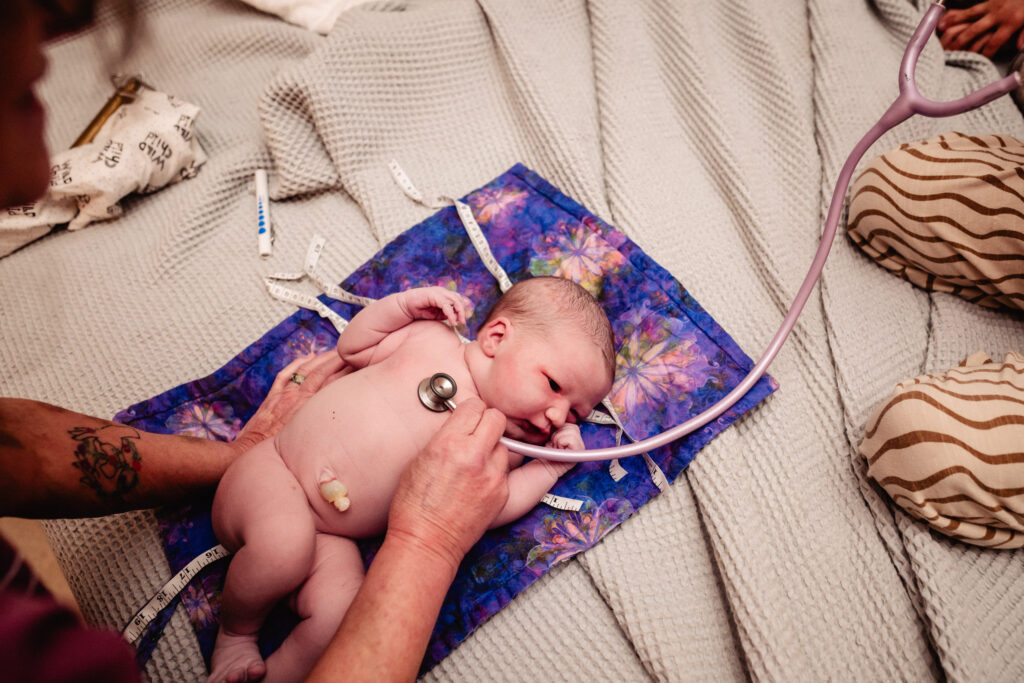 Newborn baby during exam after birth