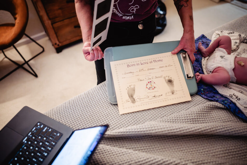 Foot prints being made for newborn baby after home birth