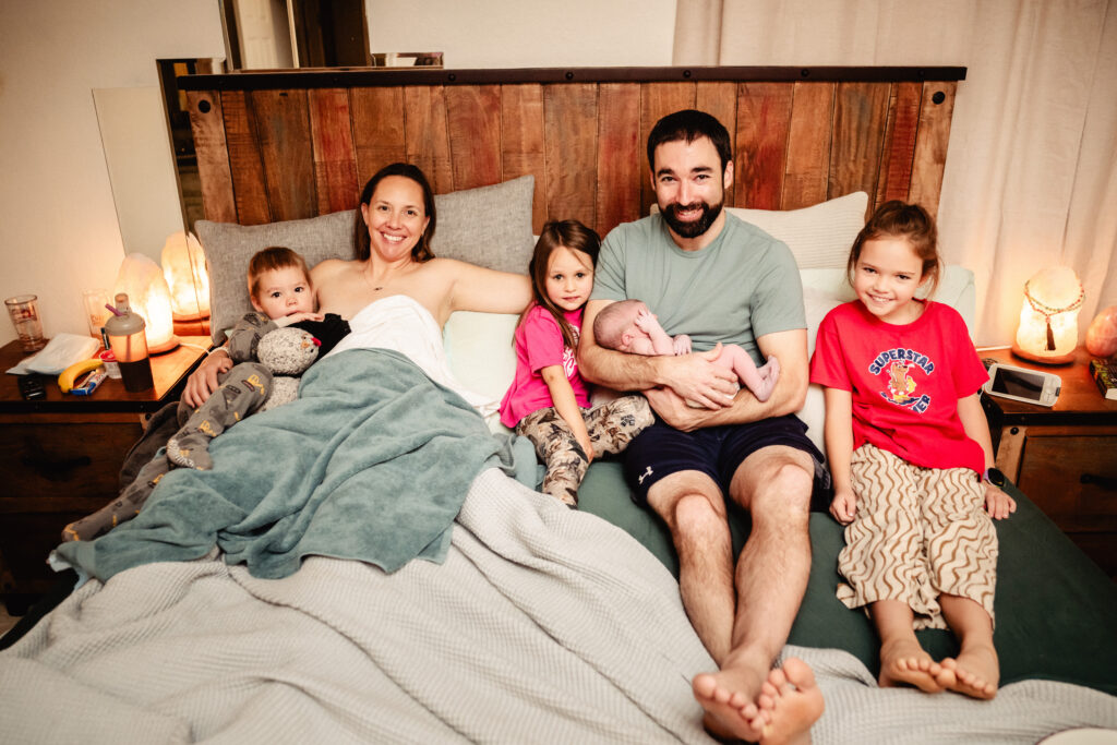 Family of 6 in bed after home birth of Rosie