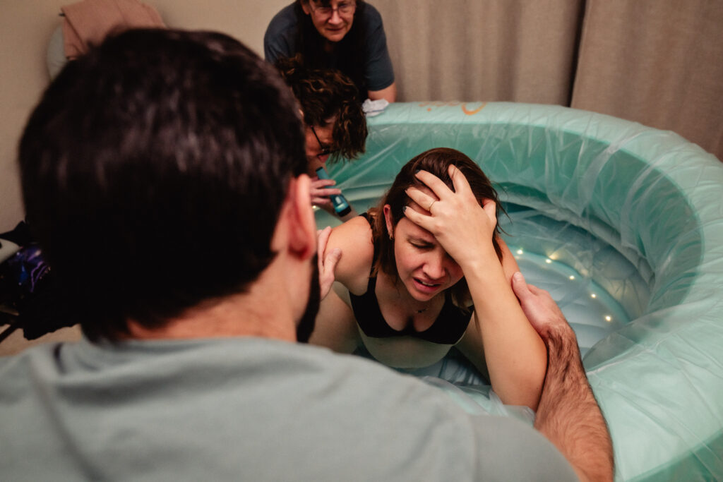 Mother laboring in birth pool near transition