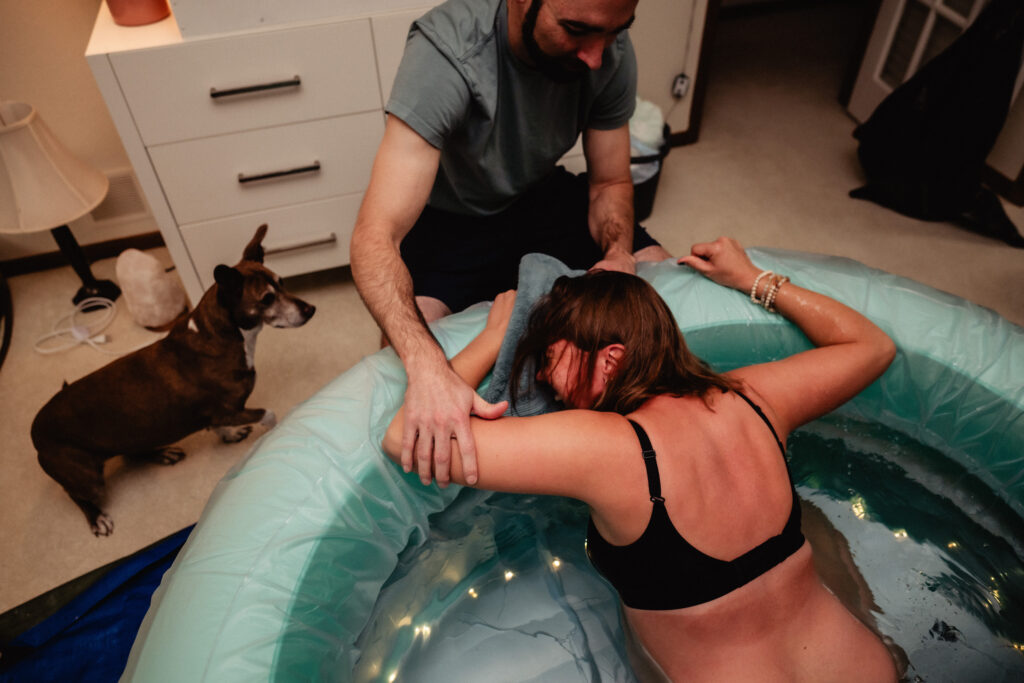 Laboring mothering in birth pool captured by birth photographer