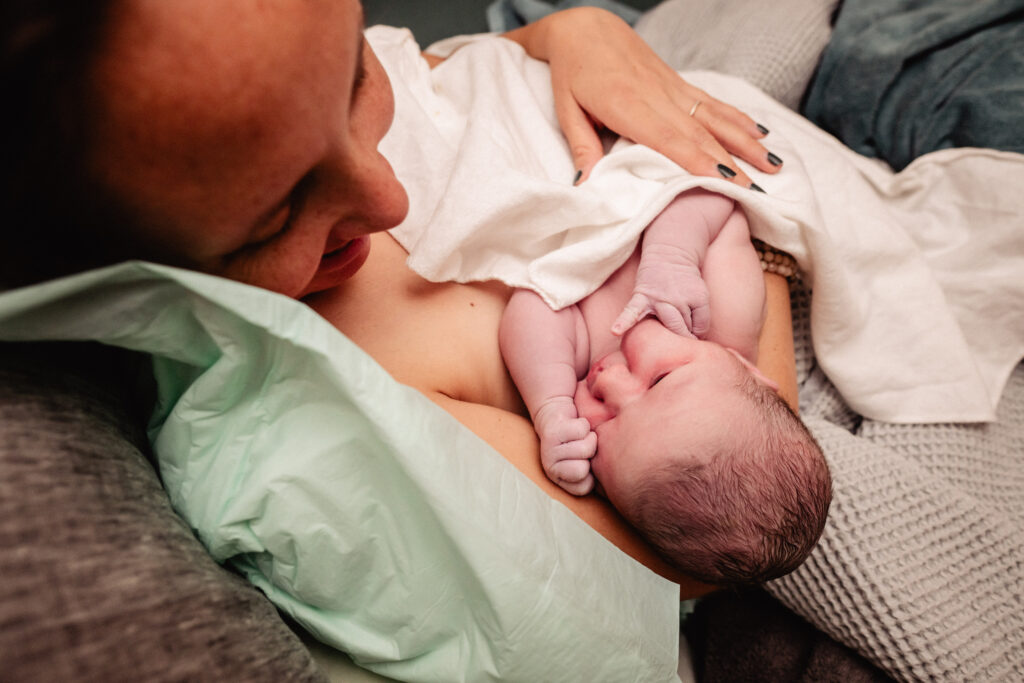 Newborn baby in mamas arms after home birth
