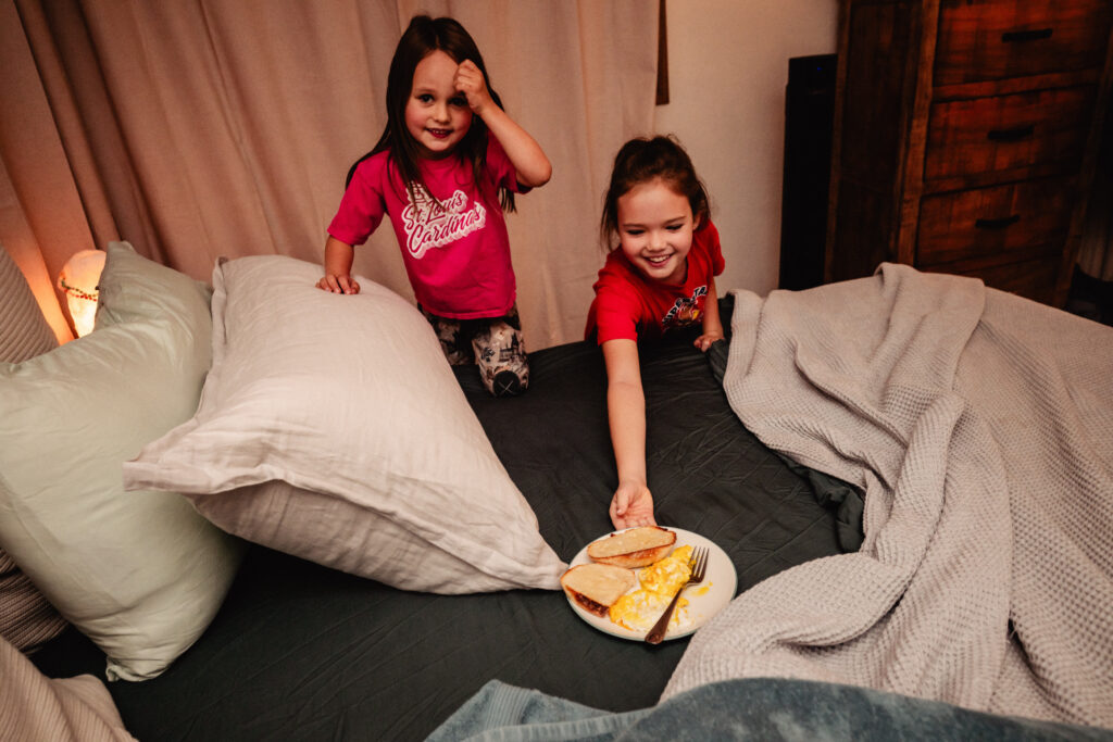 Sisters bringing new mom breakfast in bed following home birth