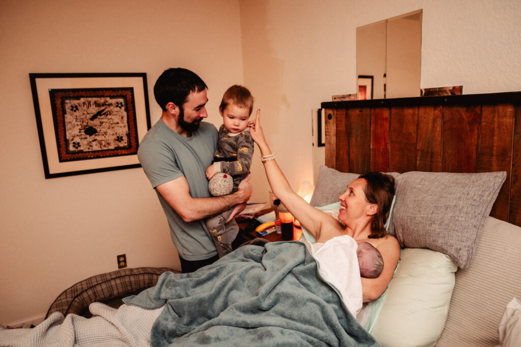 New big brother meeting baby sister after home birth